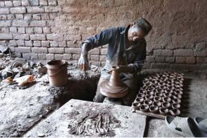 An artisan busy in preparing clay pots at his workplace in Pirwadhai area.