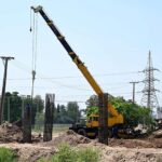 Labourers busy in construction work of flyover at under construction 10th Avenue during development work in Federal Capital