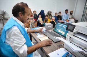 A female Afghan refugee provides fingerprints for updating her Proof of Registration (POR) card at the PCM center in Chamkani, following the government's extension until June 30, 2025.