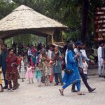 Children enjoy feeding and playing with monkeys at Zoo