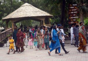 Children enjoy feeding and playing with monkeys at Zoo
