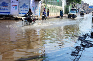A view of rain water accumulated on the road after last night's downpour is causing trouble for commuters at makki shah road in the city.