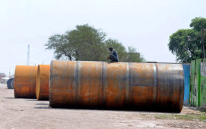 A welder is busy welding a fuel storage tank on Muzaffargarh