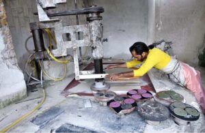 A worker is busy cutting and polishing marble at a local factory in the Federal Capital.