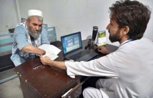 A female Afghan refugee provides fingerprints for updating her Proof of Registration (POR) card at the PCM center in Chamkani, following the government's extension until June 30, 2025.