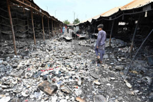 Stall holders examine and collecting the burnt remains of their stalls which burnt due to yesterday’s fire at the H-9 Weekly Bazaar