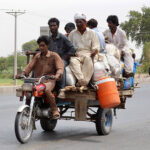 Gypsy Family is traveling on the tricycle rickshaw heading towards their destination