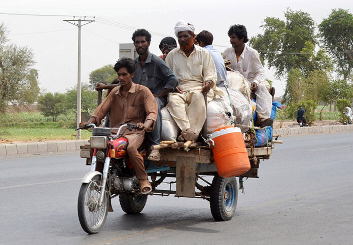 Gypsy Family is traveling on the tricycle rickshaw heading towards their destination