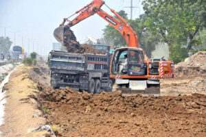 Heavy machinery being used for extension of IJP Road during development work in the Federal Capital