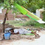 A cobbler takes a well-deserved nap after a day's work on Muzaffargarh Road