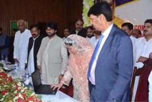 Divisional Commissioner Madam Silwat Saeed is uploading results of Matric (1st Annual) Examination 2024 on BISE website by pressing button on a laptop during a formal ceremony at Divisional Model School & College
