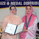 Divisional Commissioner Madam Silwat Saeed is uploading results of Matric (1st Annual) Examination 2024 on BISE website by pressing button on a laptop during a formal ceremony at Divisional Model School & College