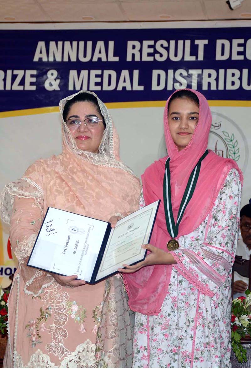 Divisional Commissioner Madam Silwat Saeed is uploading results of Matric (1st Annual) Examination 2024 on BISE website by pressing button on a laptop during a formal ceremony at Divisional Model School & College