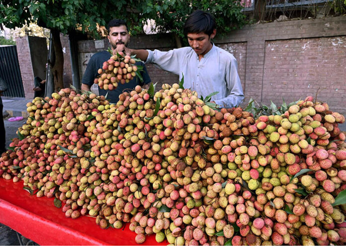 Vendor displaying fruit Lychee to attract the customers at roadside in the city