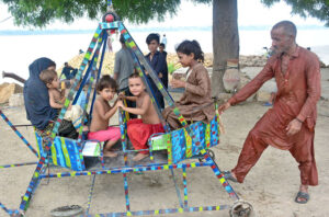 Children enjoying the swings at Latifabad.