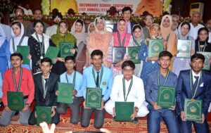 Divisional Commissioner Madam Silwat Saeed is awarding prize and medal to position holder student of Matric (1st Annual) Examination 2024 during formal result declaration ceremony at Divisional Model School & College