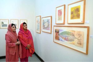 Visitors keenly viewing art work during an exhibition “Be a Catalyst; Reimaging our connection to Gaia” organized by Pakistan National Council of the Arts and OffGrid Studios at PNCA