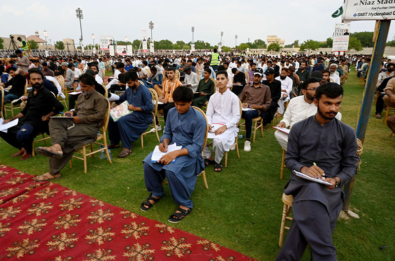 Large numbers of Students solving papers during grand entry-test for admission of Governor Sindh Kamran Tessori IT initiative Program 2024 at Niaz stadium