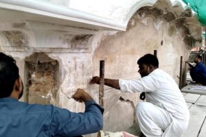 Laborers restore Nag Mandir, a Sikh-era temple, within the historic Lahore Fort, a UNESCO World Heritage Site