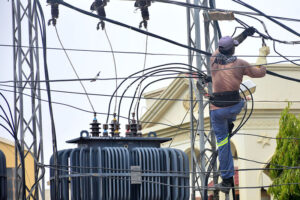 HESCO worker busy in repairing electric cable on the electric pole at Latifabad.