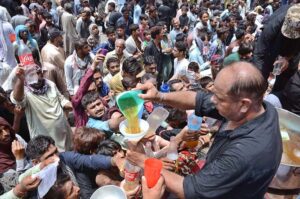 Volunteers serving food to the mourners attending the Ashura procession on 10th of Muharramul Harram. Muharram is the mourning month in remembrance of the Shahadat of Hazrat Imam Hussain (RA), the grandson of the Holy Prophet Mohammad (PBUH).
