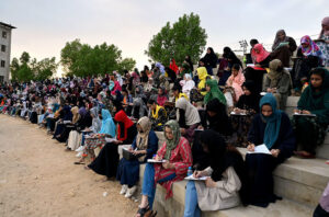 Large numbers of Students solving papers during grand entry-test for admission of Governor Sindh Kamran Tessori IT initiative Program 2024 at Niaz stadium