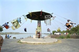 Visitors are enjoying the swing at Picnic Point near the Attock River as a large number of people have arrived to spend their holiday