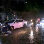 A rainy day in the city as vehicles pass along the wet roads