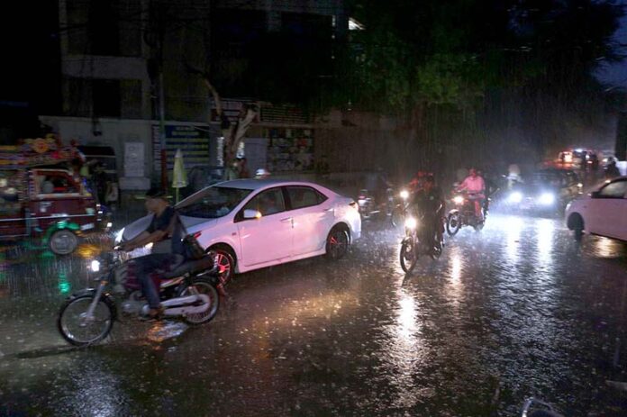 A rainy day in the city as vehicles pass along the wet roads