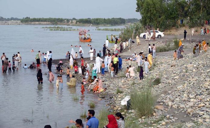 Visitors are enjoying the swing at Picnic Point near the Attock River as a large number of people have arrived to spend their holiday