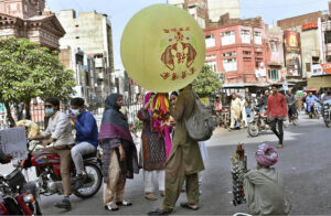 Women are busy buying balloons for children from a balloon vendor in Shalmi Bazaar.