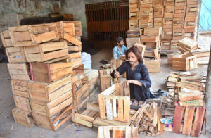 Labourers busy in preparing the wooden boxes at his workplace.