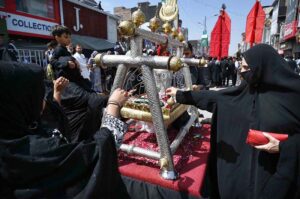 A woman with her child attending the 9th Muharram Zuljinah procession. Muharram Ul Haram is known as the first month of the Islamic calendar and the mourning month in remembrance of the martyrdom (Shahadat) of Hazrat Imam Hussain (RA), the grandson of the Holy Prophet Mohammad (PBUH).