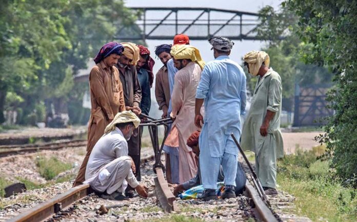 Railway workers busy in repairing work of railway tracks at Chaklala Railway Station