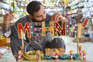 Vendor making traditional mehndi thaal used for wedding functions at Fawara Chowk.