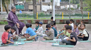 A dedicated teacher instructs children from surrounding slums in a makeshift school near F-6 in the Federal Capital.
