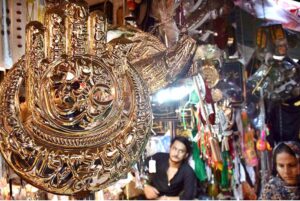 Shopkeeper displays Muharram-ul-Harram related stuff to attract the customer at Bibi Pak Daman during holy month of Muharram