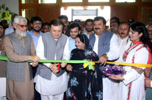 Additional Chief Secretary South Punjab Fawad Hashim Rabbani cutting the ribbon to inaugurate the mango festival at Nawaz Sharif Agricultural University.