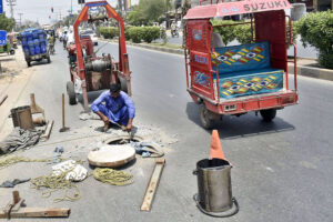 A worker busy in cleaning the main hole at Link Road.