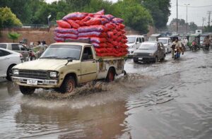 Vehicles passing through stagnant rain water accumulated in front of Governor House.