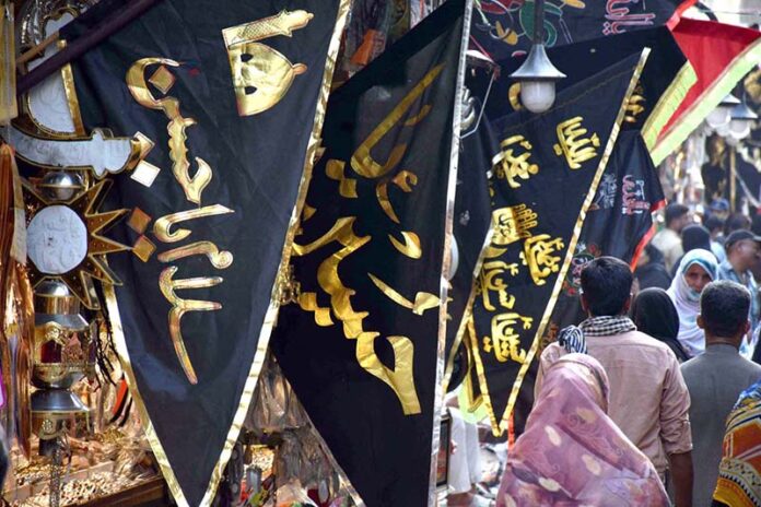 Shopkeeper displays Muharram-ul-Harram related stuff to attract the customer at Bibi Pak Daman during holy month of Muharram
