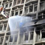 Firefighters used a snorkel to extinguish a fire that erupted on the fourth floor of the Pakistan Stock Exchange building