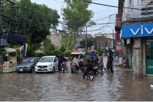 People passing through stagnant rain water after heavy rain in the city