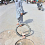 A view of open sewerage manhole on the road at Latifabad