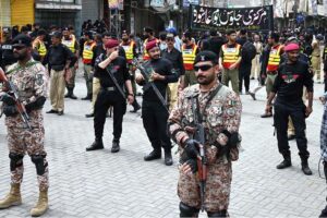 Security officials high alert in front of mourners attending the procession on 10th of Holy Month of Muharramul Harram at Station Road. Muharram is the mourning month in remembrance of the Shahadat of Hazrat Imam Hussain (RA), the Grandson of the Holy Prophet Mohammad (PBUH).