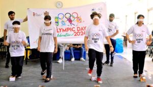 Women Sports Students lock their arms in arm wrestling while celebrating Olympic Day at the University of Faisalabad(TUF).