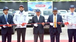 Federal Minister for Industries and Production, Mr. Rana Tanveer Hussain, is cutting the ribbon to inaugurate the vehicle export section at Toyota Indus Motors Company in Karachi