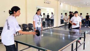 Women Sports Students lock their arms in arm wrestling while celebrating Olympic Day at the University of Faisalabad(TUF).