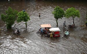 Vehicles passing through accumulated water on the road during rain in the Provincial Capital