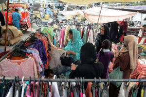 Women purchasing used clothes at Saturday Bachat Bazar